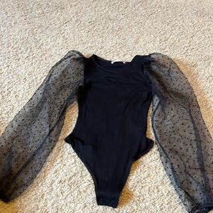 Black ribbed bodysuit with puff mesh polka dot sleeves!